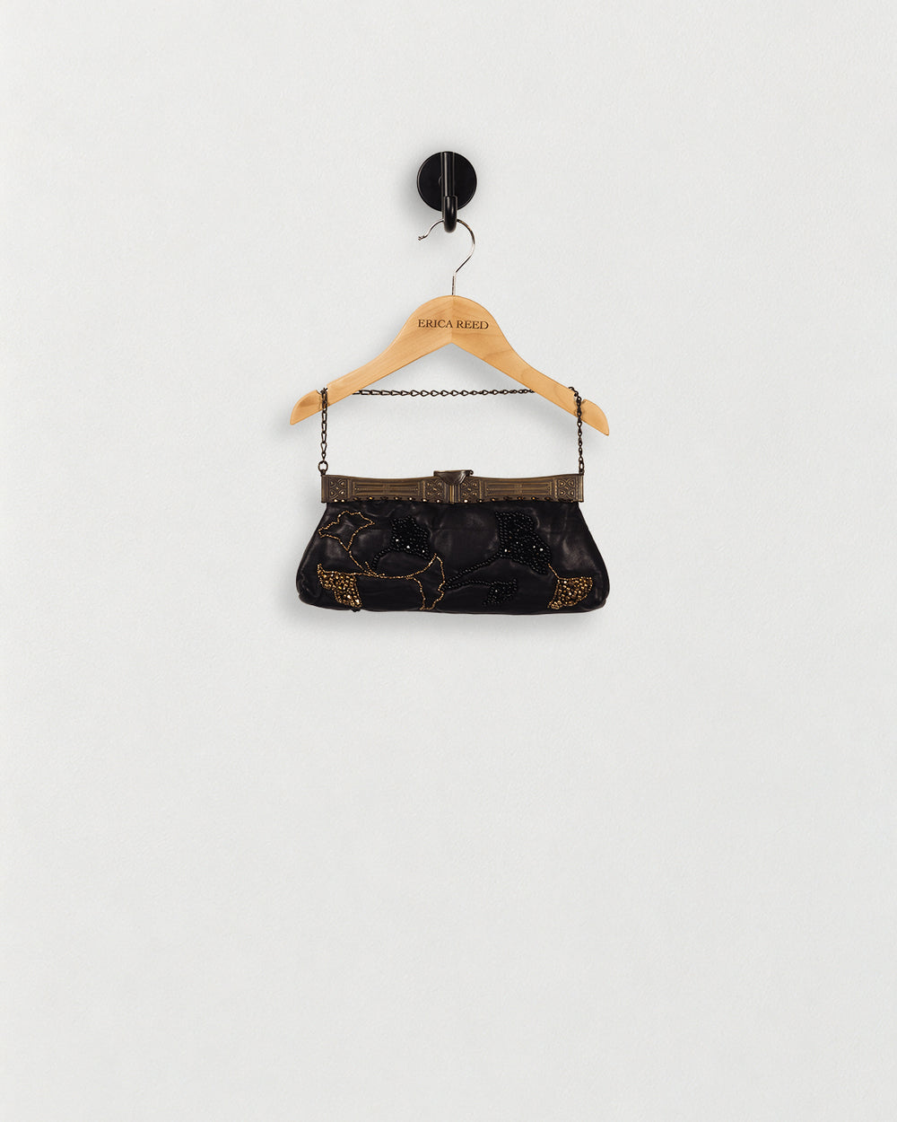 Leather Hand-Beaded Handbag — front view on an ERICA REED hanger