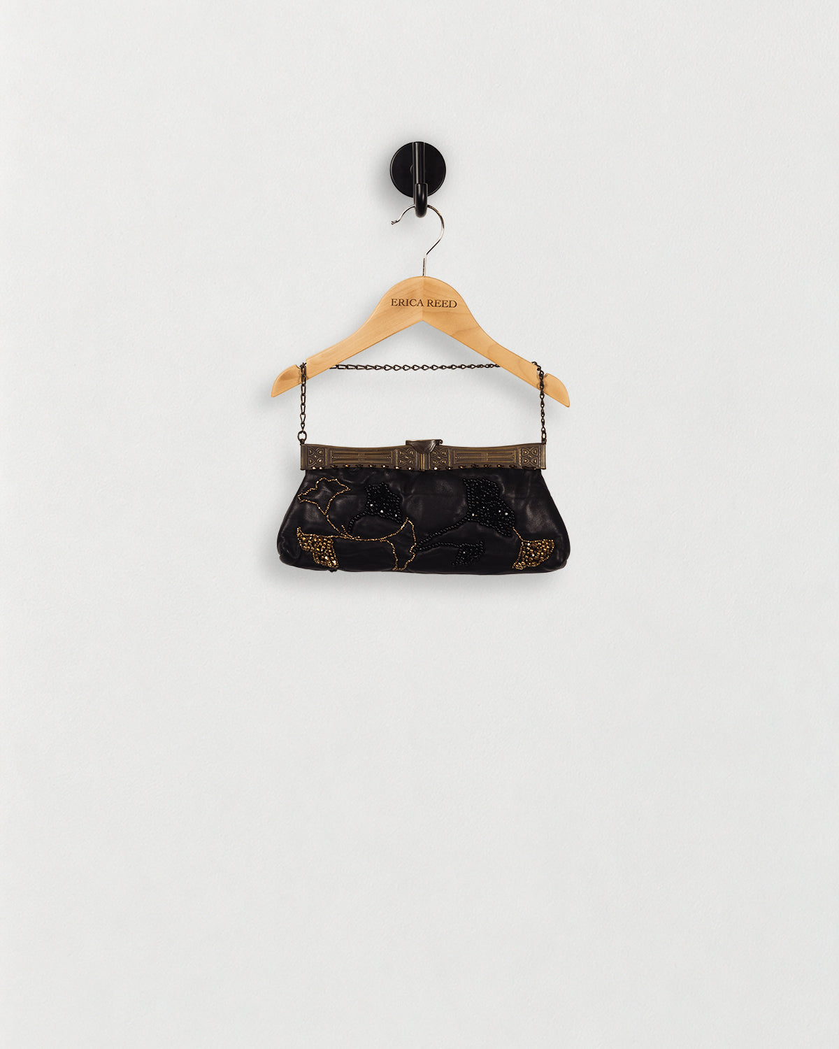 Leather Hand-Beaded Handbag — front view on an ERICA REED hanger